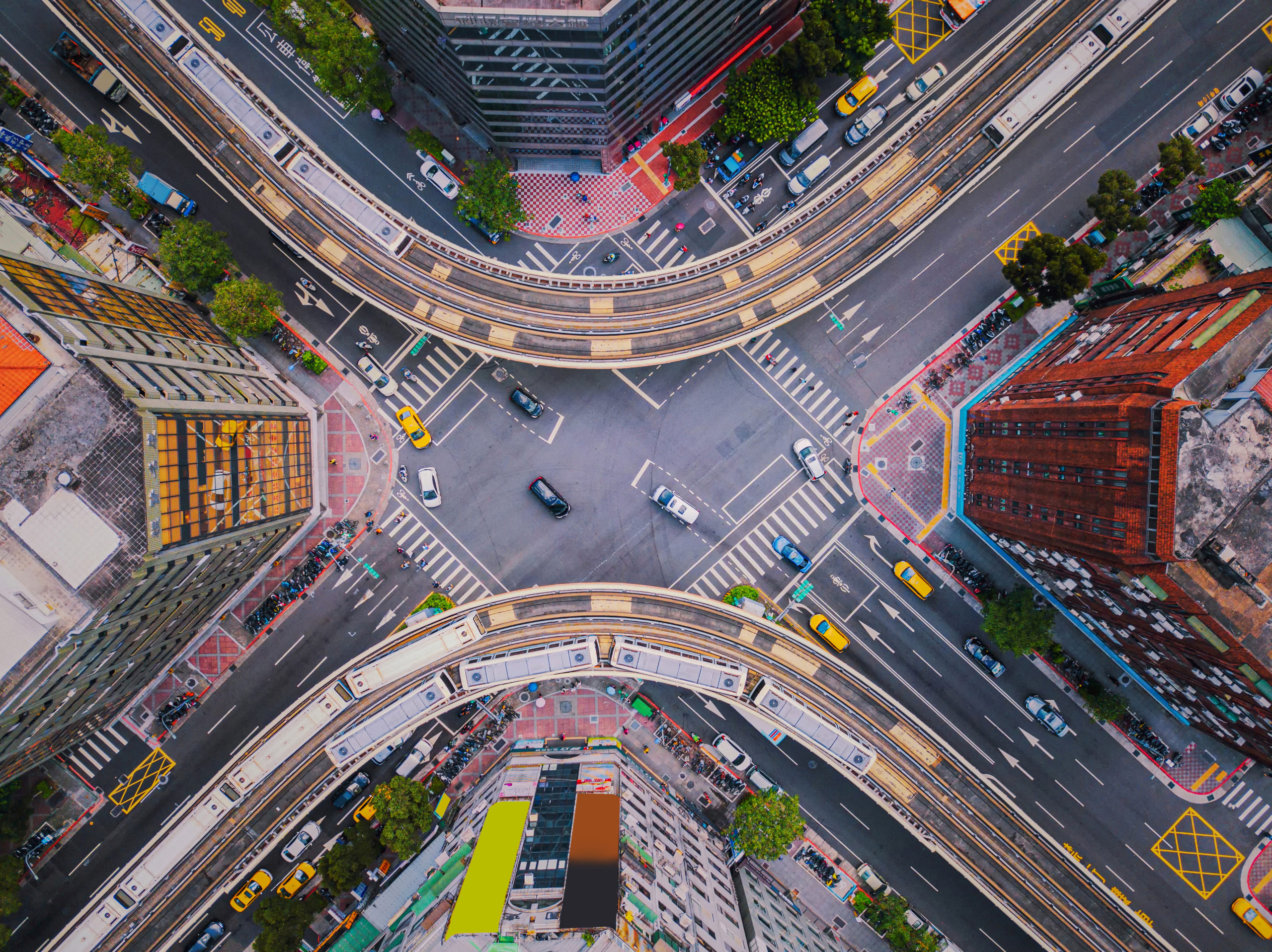 Aerial view of cars and trains with intersection or junction with traffic, Taipei Downtown, Taiwan. Financial district and business area. Smart urban city technology.